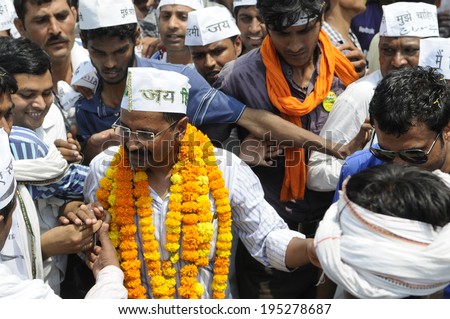 VARANASI - MAY  4 : Arvind kejriwal  being mobbed by his followers during a political meeting on May 4 , 2014 in Varanasi , India.