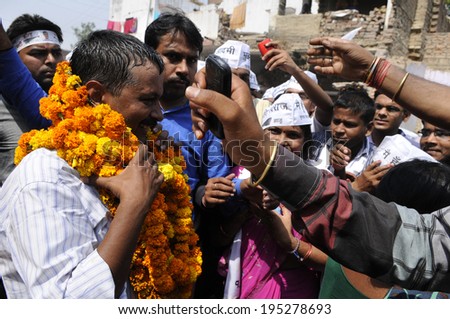 VARANASI - MAY  4 : Arvind kejriwal  being garlanded by his supporters during a political meeting on May 4 , 2014 in Varanasi , India.