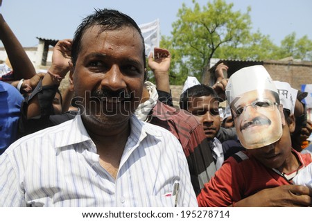 VARANASI - MAY  4 : Arvind kejriwal   looking bewildered along with one of his supporter wearing his face mask during a political meeting on May 4 , 2014 in Varanasi , India.