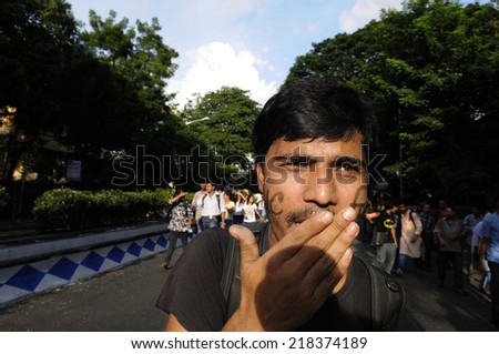 KOLKATA- SEPTEMBER 18:An angry student with is face painted during a student protest rally organized by Jadavpur university students against police atrocities on September 18, 2014  in Kolkata, India.