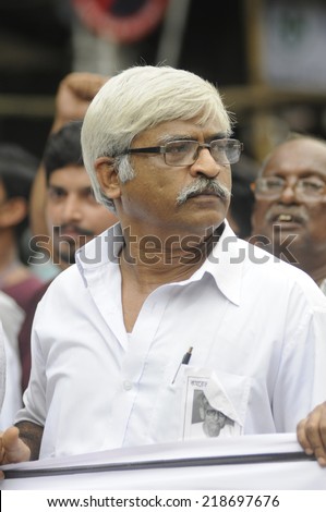 KOLKATA- SEPTEMBER 15: Sujan Chakraborty walking in a protest rally organized to demand the arrest of the persons involved in Saradha Chit fund scandal  on September 15, 2014 in Kolkata, India.