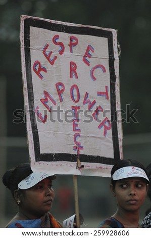 KOLKATA -DECEMBER 16:Two women holding a banner asking to respect,empower women during a rally to remember the gang raped victim from New Delhi in the year 2012 -on December 16,2014 in Kolkata ,India.