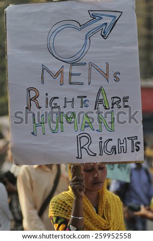 KOLKATA - NOVEMBER 15 : A muslim woman carrying  men\'s day signs  saying \