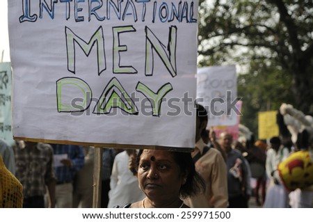 KOLKATA - NOVEMBER 15 : A woman holding International Men\'s Day sign  during a rally to celebrate the International Men\'s Day on November 15, 2014 in Kolkata, India.