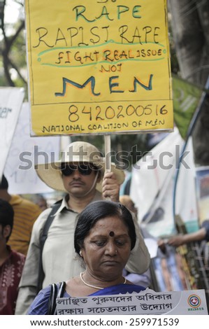 KOLKATA - NOVEMBER 15 : A woman looking downwards while marching in a rally to celebrate the International Men\'s Day on November 15, 2014 in Kolkata, India.