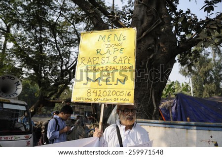 KOLKATA - NOVEMBER 15 :An old man with sign differentiating between a rapist and men during a rally to celebrate the International Men\'s Day on November 15, 2014 in Kolkata, India.