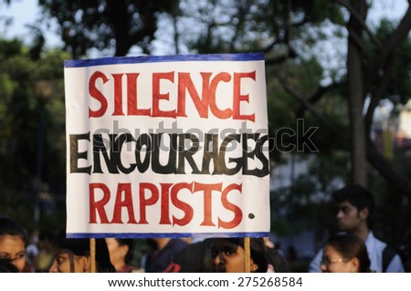 KOLKATA - MARCH 16 : School kids holding sign asking people to speak up during a candle light vigil to protest gang rape of an elderly nun on March 16, 2015, at Allen Park in Kolkata, India.