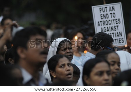 KOLKATA - MARCH 16 : Mourners singing songs during a candle light vigil to protest gang rape of an elderly nun on March 16, 2015, at Allen Park in Kolkata, India.