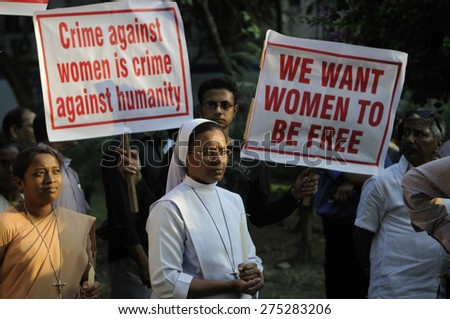 KOLKATA - MARCH 16 : A Christian Nun standing in prayer during a candle light vigil to protest gang rape of an elderly nun near Ranaghat on March 16, 2015 at Allen Park in Kolkata, India.