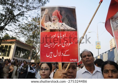 KOLKATA - JANUARY 24:Protestors with anti Modi signs written in Urdu during a rally to protest Obama\'s three day visit India to attend India\'s Republic Day parade on January 24, 2015 in Kolkata,India.