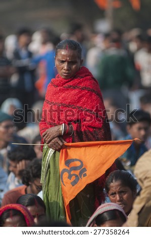 KOLKATA - DECEMBER 20: A woman supporter carrying a 