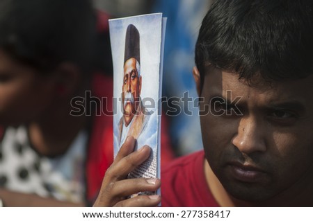 KOLKATA - DECEMBER 20: A man covering his face with a book to protect from heat during the Golden Jubilee celebration of VHP- a Hindu nationalist organization on December 20, 2014 in Kolkata,India.