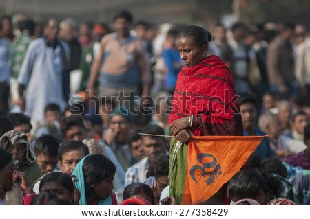 KOLKATA - DECEMBER 20: A woman supporter carrying a \