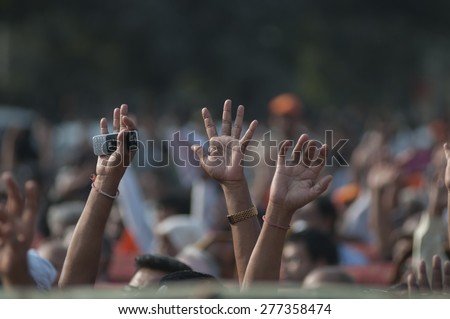 KOLKATA - DECEMBER 20:Supporters raising hands in support during the Golden Jubilee celebration of Vishwa Hindu Parishad (VHP)- a Hindu nationalist organization on December 20, 2014 in Kolkata,India.