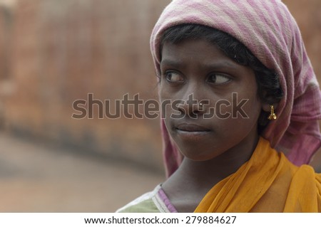KOLKATA - OCTOBER 26 : A teenage girl - one of many girls working in brick manufacturing industry where they live and work under unhealthy and unsafe conditions on October 26, 2014 in Kolkata , India.
