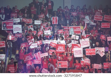 BRAMPTON - OCTOBER 4 : Liberal party supporters chanting slogans and hoisting banners during an election rally of the Liberal Party of Canada on October 4, 2015 in Brampton, Canada.