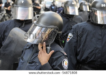 TORONTO-JUNE 25:  A Toronto Police  Sergent in riot gear listens to his radio for instructions  during the G20 Protest on June 25, 2010 in Toronto, Canada.