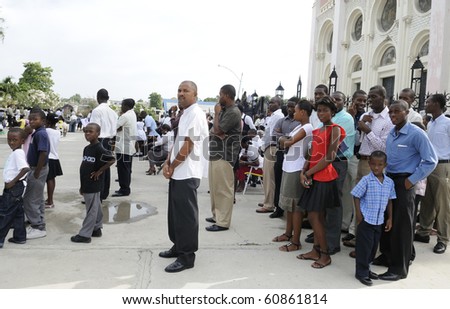 PORT-AU-PRINCE - AUGUST 22: People waiting outside a broken church for their Sunday prayers,  in Port-Au-Prince, Haiti on August 22, 2010.
