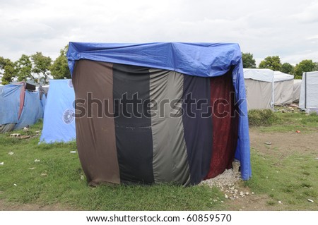 LEOGANE - AUGUST 27: Residents build their tents with plain cloths as the plastic was washed away by heavy rain, on August 27, 2010 in Leogane, Haiti