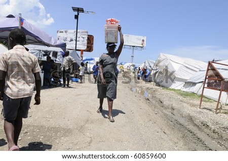 PORT-AU-PRINCE - AUGUST 28:  A woman selling  cold drinks during  hot and humid afternoon in one of the tent cities  in  Port-Au-Prince, Haiti on August 28, 2010.