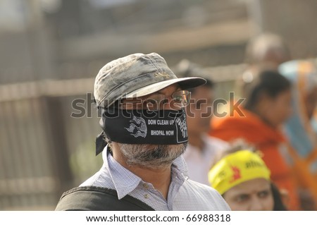 BHOPAL- DECEMBER 3: A man covers his face with a band asking Dow Chemical to clean Bhopal during the rally to mark the 26th year of the Bhopal Gas Disaster, in Bhopal - India on December 3,2010.