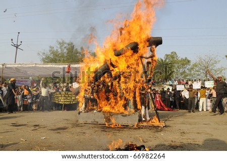 BHOPAL- DECEMBER 3: The burning effigy close to the boundary wall of the Union Carbide Gas Plant ,in Bhopal - India on December 3, 2010.