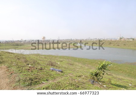 BHOPAL-DECEMBER 4:The dumping ground of the Union Carbide gas plant where they dumped their chemical waste after the gas disaster in 1984,with the plant at distant in Bhopal-India on December 4,2010.