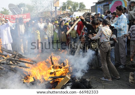 BHOPAL- DECEMBER 3: Angry and violent mob in front of the burning effigy during the rally to mark the 26th Year of the Bhopal Gas Disaster in Bhopal - India on December 3, 2010.