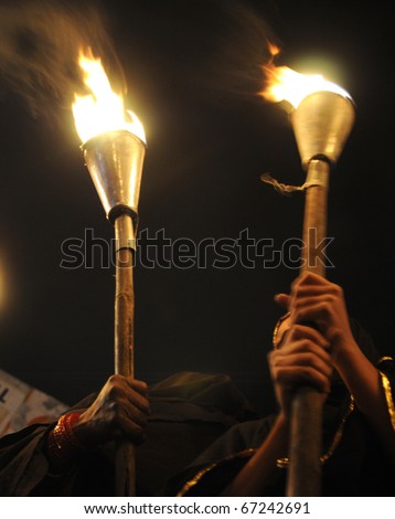 BHOPAL- DECEMBER 2: Strong hands of woman of Bhopal  during the torch rally organized to mark the 26th year of Bhopal gas disaster in Bhopal - India on December 2, 2010.