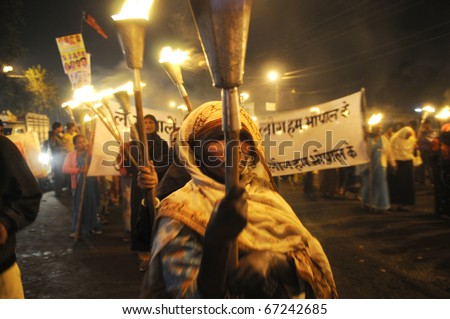 BHOPAL- DECEMBER 2: An old woman participate in the protest during the torch rally organized to mark the 26th year of Bhopal gas disaster, in Bhopal - India on December 2, 2010.