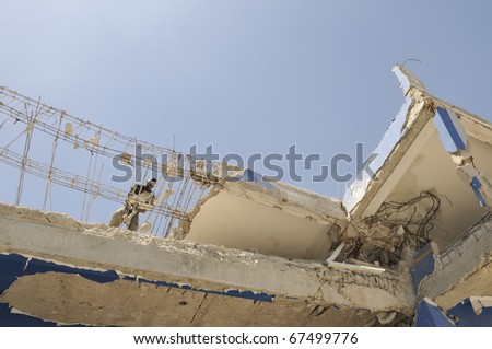 PORT-AU-PRINCE - AUGUST 30:  An Haitian worker  breaking  down the rubble in Port-Au-Prince, Haiti on August 30, 2010.