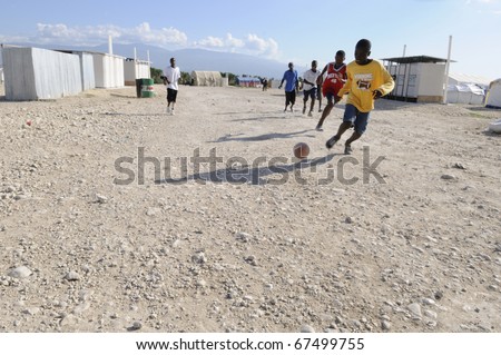 PORT-AU-PRINCE - AUGUST 30:  Haitian teenagers playing soccer in the tent camps , a favorite sport of the Haitians,  in Port-Au-Prince, Haiti on August 30, 2010.