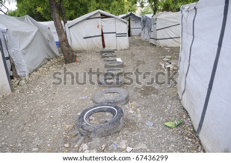 PORT-AU-PRINCE - AUGUST 26:  Series of tires in front of the tents as a walkway to be used during heavy rainfall,in Port-Au-Prince, Haiti on August 26, 2010.