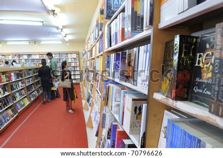 KOLKATA- FEBRUARY 4: A visitor looks carefully at a large selection of English books in a book stall during the 2011 Kolkata Book Fair in Kolkata, India on February 4, 2011.