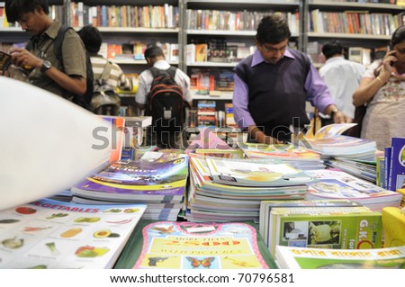 KOLKATA- FEBRUARY 4: People read books inside a book stall  during the 2011 Kolkata Book fair  in Kolkata, India on February 4, 2011.