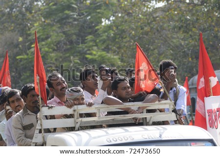 KOLKATA- FEBRUARY 13: Supporters flocking in on roofs of vehicles during a political rally  in Kolkata, India on February 13, 2011.