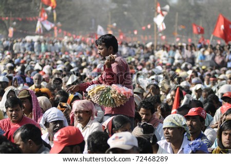KOLKATA- FEBRUARY 13:   A vendor looking for customers amongst the crowd  during a political rally  in Kolkata, India on February 13, 2011.