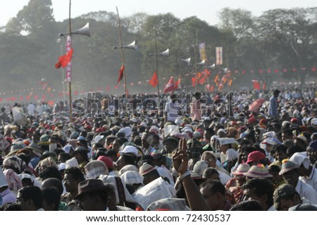 KOLKATA- FEBRUARY 13:   People listen to the upcoming election agenda\'s during a political rally  in Kolkata, India on February 13, 2011.