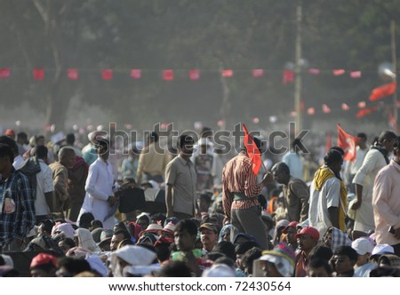 KOLKATA- FEBRUARY 13:  A supporter makes his way out, through the sitting crowd  during a political rally  in Kolkata, India on February 13, 2011.