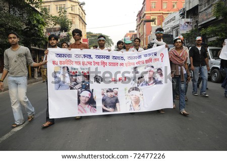 KOLKATA- DECEMBER 20: Members of the student union walks with a banner with images of the victims of political enmity,  during a silent rally in Kolkata, India on December 20, 2010.