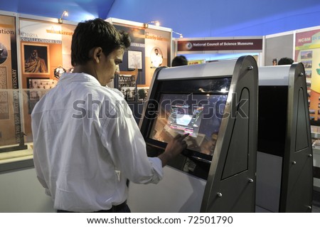 KOLKATA- FEBRUARY 20: A  young man operates a touch screen, during the Information and Communication Technology (ICT) conference and exhibition in Kolkata, India on February 20, 2011.