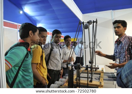 KOLKATA- FEBRUARY 20: Visitors ask the maker of the Pendulum questions during the Information and Communication Technology conference and exhibition on February 20, 2011 in Kolkata, India.