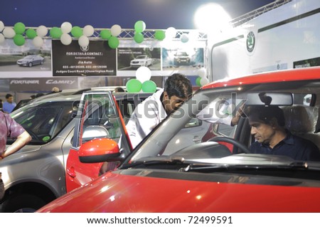 KOLKATA- FEBRUARY 20: A car sales representative talks to a customer, during the Information and Communication Technology (ICT) conference and exhibition in Kolkata, India on February 20, 2011.