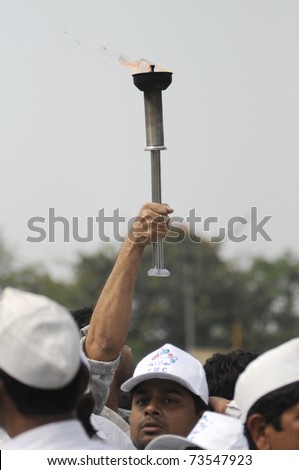 KOLKATA - FEBRUARY 20: Supporters of All India Trinamool Congress holding a flamed torch  during a rally organized to kick the 2011 election champagne, in Kolkata, India on February 20, 2011.