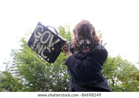 TORONTO - OCTOBER 15:  A protestor masked as a wolf makes mockery of the 