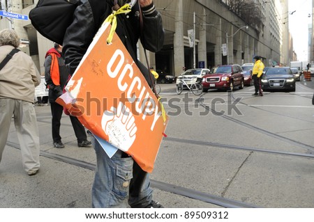 TORONTO - NOVEMBER 24:  A protester on roller blades passing an intersection  blocked by the police during a rally on November 24, 2011 in Toronto, Canada.