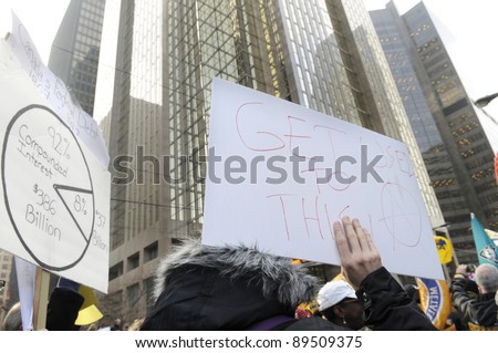 TORONTO - NOVEMBER 24: A protester listening to the speakers while occupying the entrance of Toronto Stock Exchange in Downtown Toronto on November 24, 2011 in Toronto, Canada.