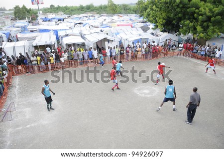 PORT-AU-PRINCE - AUGUST 26: Resident enjoying one of their primary form of entertainment- a soccer game in one of the tent cities  in Port-Au-Prince, Haiti on August 26, 2010.