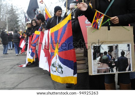 TORONTO - MARCH 10: Tibetans with picture of Chinese atrocities  marching in a rally organized to protest against the Chinese occupation of Tibet on March 10 2009 in Toronto, Canada.