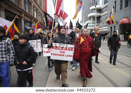 TORONTO - MARCH 10:  Buddhist Monks  marching in a rally organized to protest against the Chinese occupation of Tibet on March 10 2009 in Toronto, Canada.